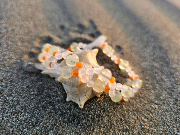 Healing Heart Gemstone Bracelet on a shell at the beach