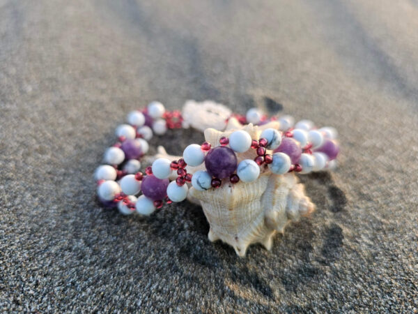 Healing Peace gemstone bracelet on a sand on a shell