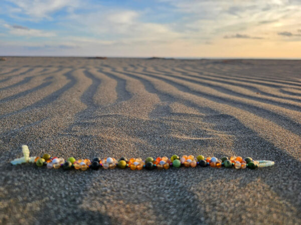 Flower of Life bracelet on the sand